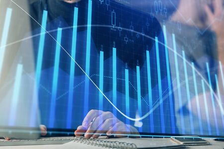Forex graph with businessman typing on computer in office on background. Concept of analysis. Double...