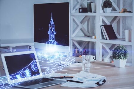 Desktop computer background in office and start up theme hologram drawing. Double exposure. Startup concept.の写真素材