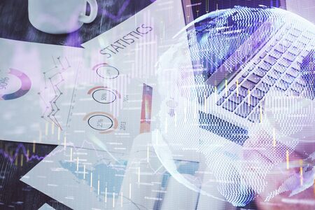 Double exposure of stock graph with businessman typing on computer in office on background. Concept...