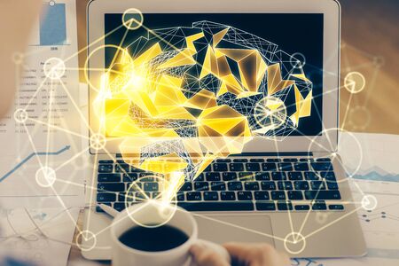 Multi exposure of work space with computer and human brain hologram. Brainstorm concept.