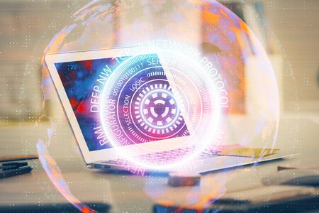 Computer on desktop in office with technology theme hologram. Multi exposure. Tech concept.の写真素材