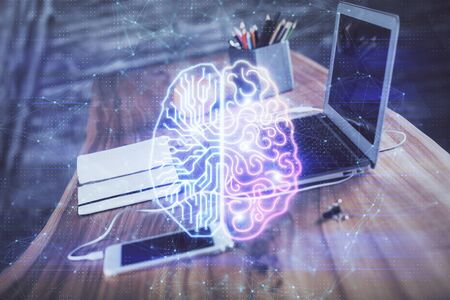 Double exposure of table with computer and brain hologram. Data innovation concept.