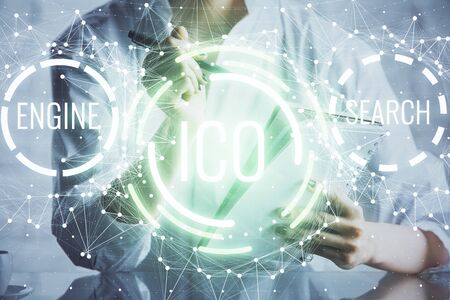 Cryptocurrency hologram, bitcoin, ico theme over hands taking notes background. Concept of blockchain. Multi exposureの写真素材