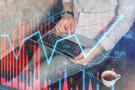 Forex graph with businessman working on computer in office on background. Concept of analysis....