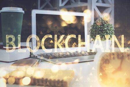 Multi exposure of blockchain and crypto economy theme hologram and table with computer background. Concept of bitcoin cryptocurrency.の写真素材