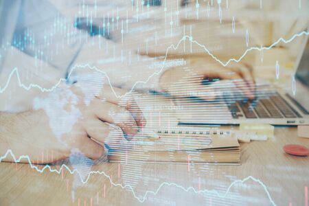 Multi exposure of financial graph with man works in office on background. Concept of analysis.の写真素材