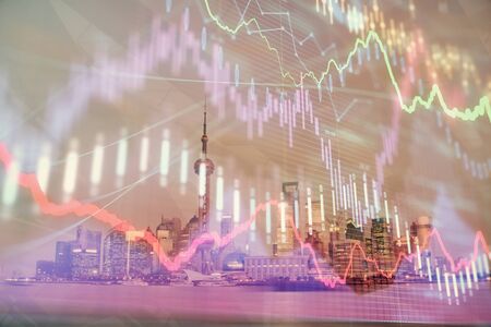 Forex chart on cityscape with tall buildings background multi exposure. Financial research concept.の写真素材
