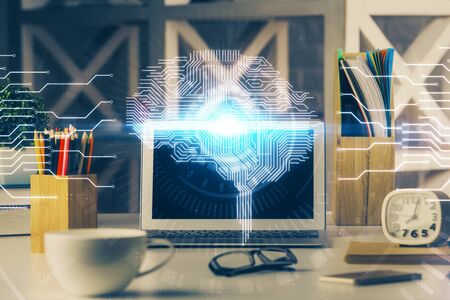 Double exposure of work space with computer and human brain drawing hologram. Brainstorm concept.