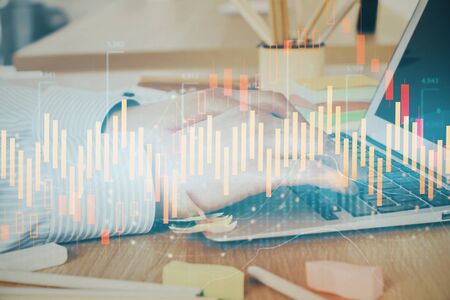 Multi exposure of stock market graph with man working on laptop on background. Concept of financial analysis.の写真素材