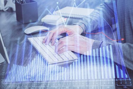 Multi exposure of financial graph with man works in office on background. Concept of analysis.の写真素材