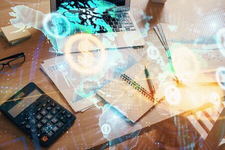 Forex market graph hologram and laptop on background. Double exposure. Concept of investment.の写真素材