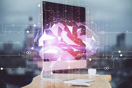 Double exposure of table with computer and brain hologram. Data innovation concept.