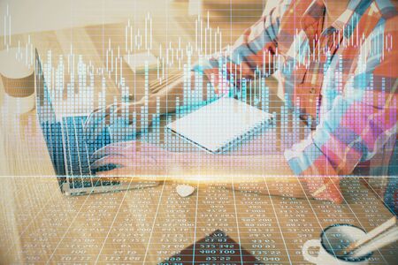 Multi exposure of forex graph with man working on computerの写真素材