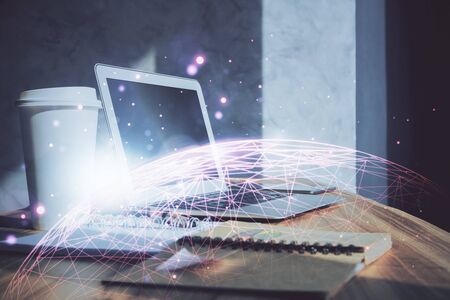 Computer on desktop with social network hologram. Multi exposure. Concept of international people connections.の写真素材