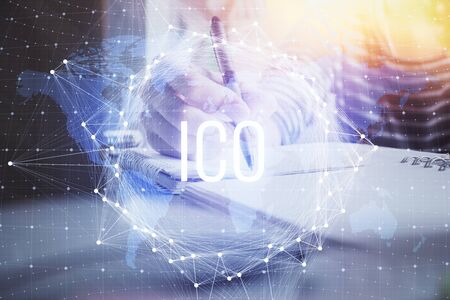 Cryptocurrency hologram, bitcoin, ico theme over hands taking notes background. Concept of blockchain. Multi exposureの写真素材