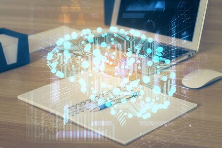 Multi exposure of work table with computer and brain hologram. Brainstorm concept.