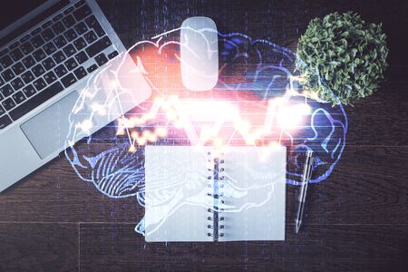 Double exposure of brain drawing hologram over topview work table background with computer. Concept...