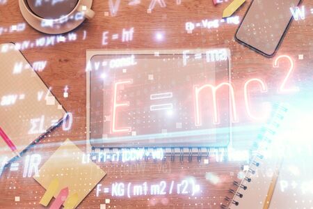 Double exposure of formula drawing over table with phone. Top view. Education concept.