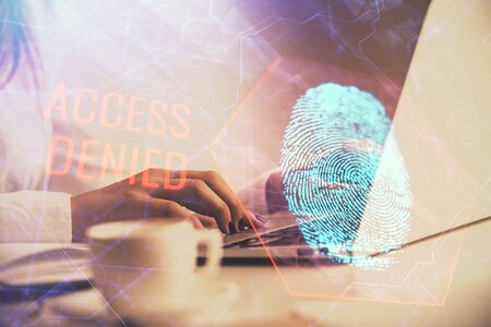 Double exposure of woman hands typing on computer and fingerprint drawing. Security concept.