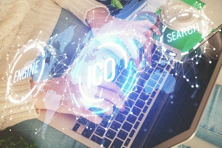 Double exposure of woman hands typing on computer and crypto market theme hologram drawing. Blockchain concept.の写真素材