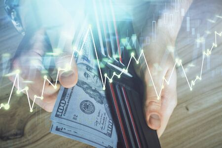 Multi exposure of forex graph drawing hologram and USA dollars bills and man hands. Technical Analysis concept.の写真素材