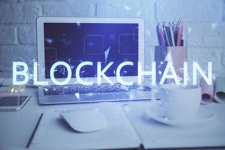 Multi exposure of blockchain and crypto economy theme hologram and table with computer background. Concept of bitcoin cryptocurrency.の写真素材