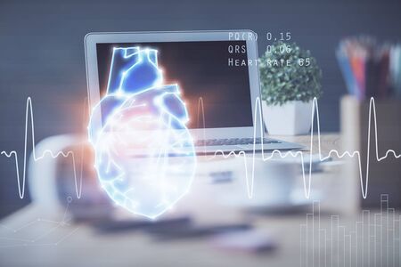 Desktop computer background and heart drawing. Double exposure. Medical study and healthcare concept.の写真素材