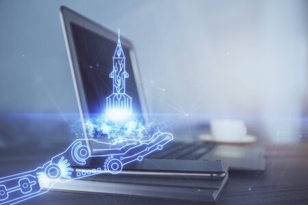 Desktop computer background in office and start up theme hologram drawing. Double exposure. Startup...