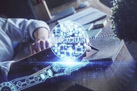Cryptocurrency hologram, bitcoin, ico theme over hands taking notes background. Concept of blockchain. Multi exposureの写真素材