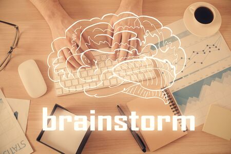 Double exposure of mans hands typing over computer keyboard and conceptual start up theme drawing. Top view.の写真素材