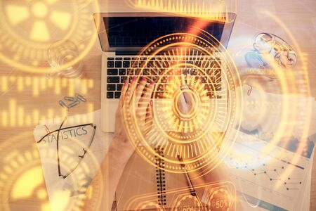 Double exposure of woman hands working on computer and tech theme hologram drawing. Top View. Technology concept.の写真素材