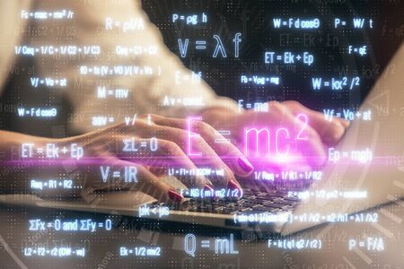 Double exposure of woman hands typing on computer and formula hologram drawing. Education concept.
