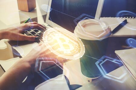 Double exposure of woman hands typing on computer and crypto market theme hologram drawing. Blockchain concept.の写真素材