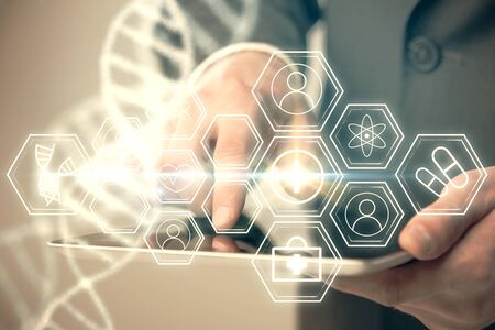 Double exposure of man's hands holding and using a phone and DNA drawing. Medical education concept.