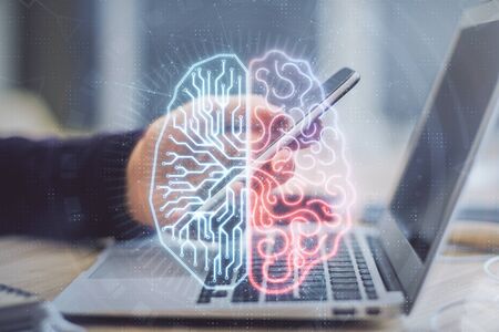 Double exposure of mans hand holding and using a digital device and brain hologram drawing. Data concept.の写真素材