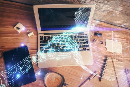 Technology hologram drawing over computer on the desktop background. Top view. Double exposure. Tech concept.の写真素材