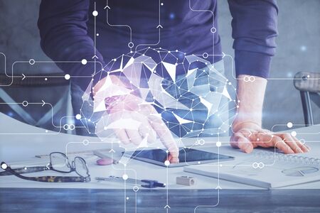 Double exposure of mans hand holding and using a digital device and brain hologram drawing. Data...