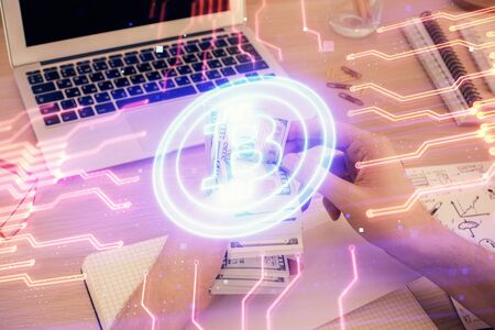 Multi exposure of blockchain theme drawing hologram and USA dollars bills and man hands. Business concept.の写真素材