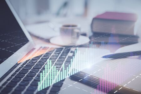 Double exposure of financial chart drawing and desktop with coffee and items on table background. Concept of forex market tradingの写真素材
