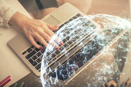 Double exposure of woman hands typing on computer and social network theme hologram drawing. People media concept.の写真素材