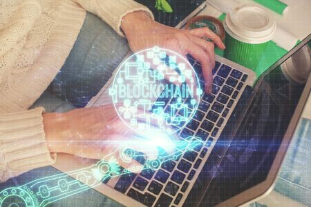 Double exposure of woman hands typing on computer and crypto market theme hologram drawing....