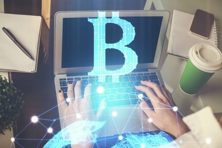 Double exposure of woman hands typing on computer and crypto market theme hologram drawing....