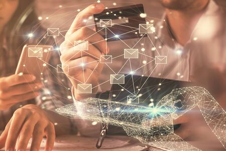 Double exposure of man and woman on-line shopping holding a credit card and envelop fly hologram drawing. E-mail concept.の写真素材