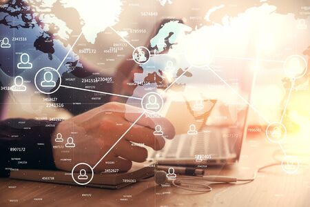 Double exposure of mans hands holding and using a phone and social network theme drawing.