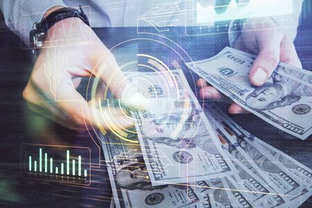 Double exposure of technology drawing hologram and us dollars bills and man hands. Data concept