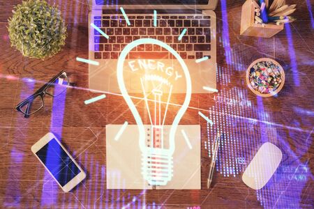 Bulb drawing over computer on the desktop background. Top view. Double exposure. Idea concept.の写真素材