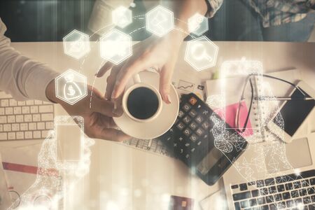 Double exposure of man and woman working together and technology theme drawing. Computer background. Top View. High tech concept.の写真素材