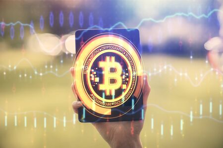 Double exposure of blockchain business sketch hologram and woman holding and using a mobile device.