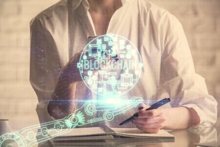 Double exposure of blockchain business sketch hologram and woman holding and using a mobile device.