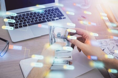 Multi exposure of technology drawing hologram and us dollars bills and man hands. Data conceptの写真素材